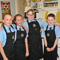 pupils wearing aprons