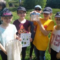 children outdoors wearing caps