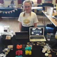 girl smiling standing by her invention