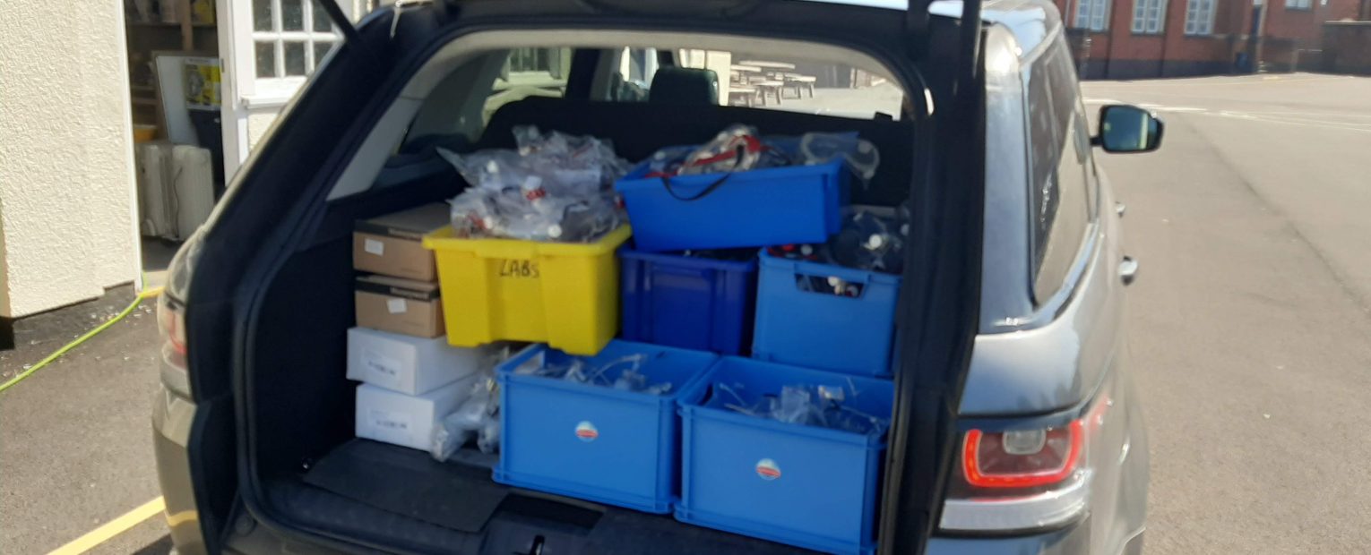A car boot with PPE equipment inside boxes