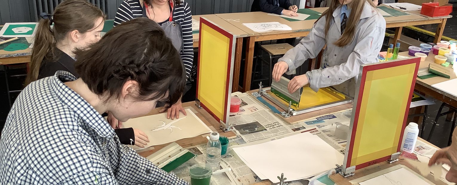 Students practicing screen printing