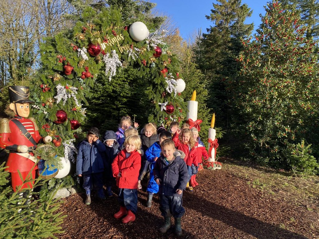 children outside near Christmas trees